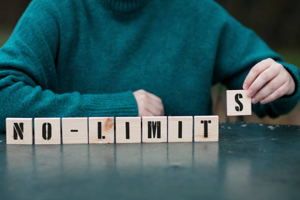 NO LIMITS Concept ,Female hand playing with nine wooden blocks