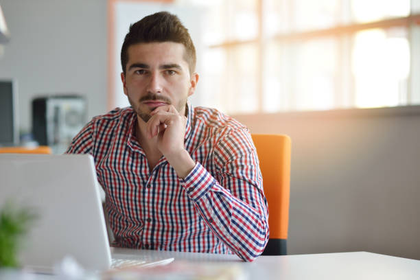 istock Man in modern office start-up working on laptop. 939858692