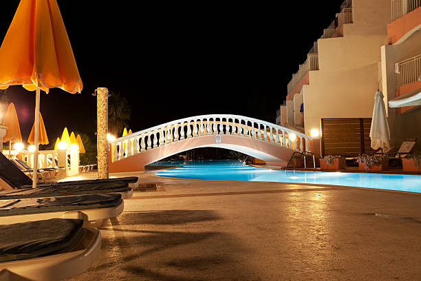 Small wooden bridge over water pool at holiday resort