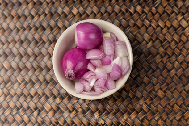 red onions peeled and chopped red onion isolated in a cup white. - claret cup imagens e fotografias de stock