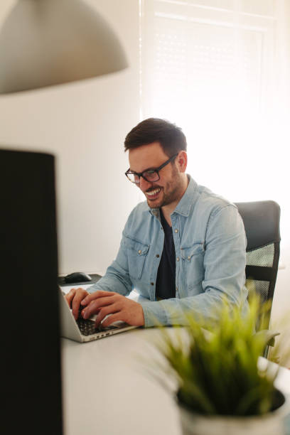 istock Male executive working over laptop and graphic tablet at his desk 939866676