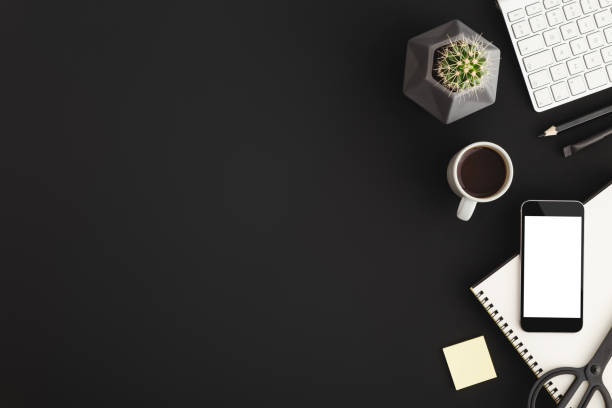 istock Black office workspace with smartphone and office supply. Flat lay 939869228