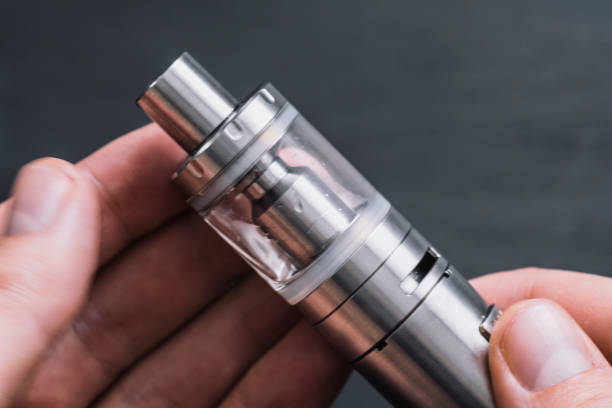 istock Vaping device in in the man's hand. Electronic cigarette, vape 939869336