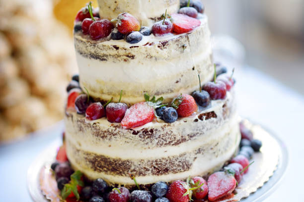 istock Delicious chocolate wedding cake decorated with fruits and berries 939870898