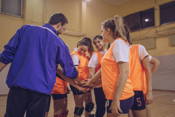 istock Coach and players holding hands 939873598