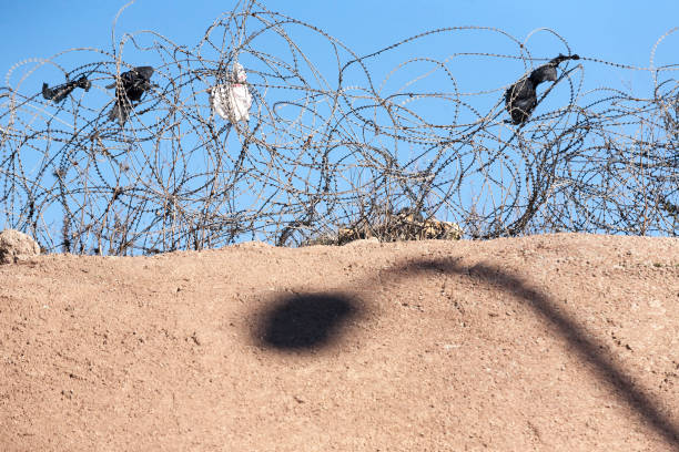 istock Barbed wire on a desert - like countryside 939876674