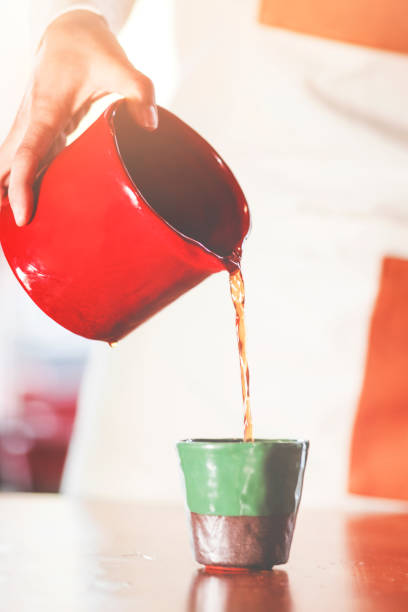 istock Drip coffee, barista pouring water on coffee ground with filter 939879012