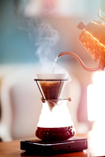 Drip coffee, barista pouring water on coffee ground with filter