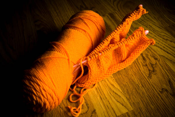 Knitting thread and needles in orange.