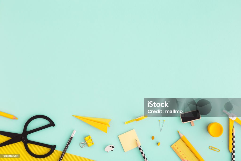 Back to school background with yellow school supplies Flat lay. Creative, fashionable, minimal, school background with yellow supplies on cyan blue background. Back to school. Flat lay. Creativity Stock Photo