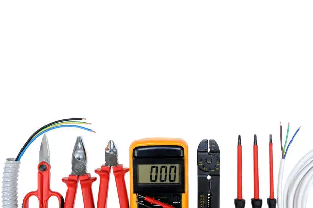 Photo of Top view of work tools for residential electrical installation on white background.