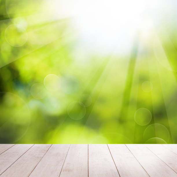 istock Abstract Summer Background with White Empty Wooden Table and Bokeh Light 939891530