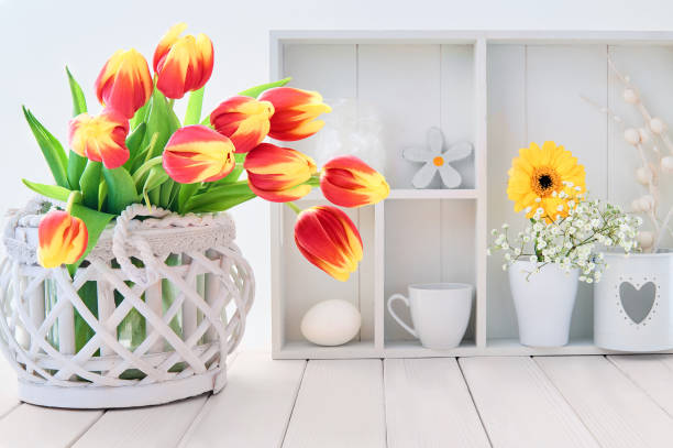 istock White table with red and yellow tulips and springtime decorations 939892160