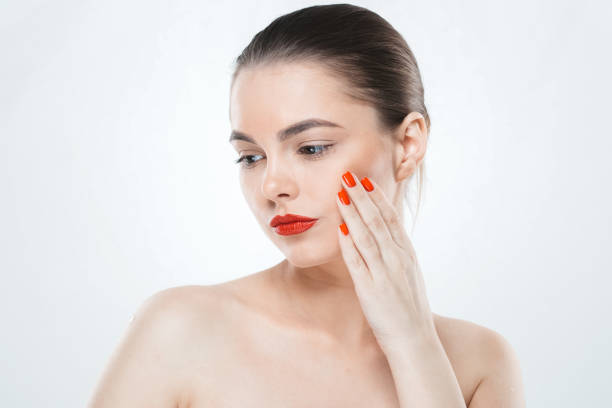 Red nails and lips model woman isolated on white. Color makeup. Studio shot.