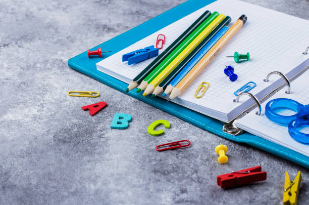 istock School supplies on wooden background 939911872