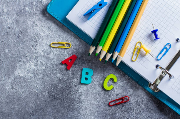 istock School supplies on wooden background 939911882