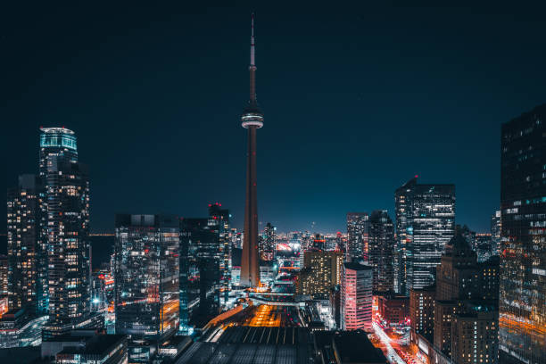 Modern Futuristic Night Toronto City Skyline Epic futuristic and modern skyline views of downtown Toronto with the train tracks leading your eye to office buildings and condominiums. toronto stock pictures, royalty-free photos & images