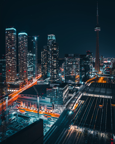 Epic futuristic and modern skyline views of downtown Toronto with the train tracks leading your eye to office buildings and condominiums.