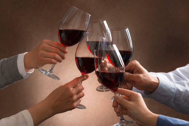 People have a toast with red wine