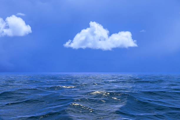 istock Background of sky with a single cloud reflected in water or ocea 939927086