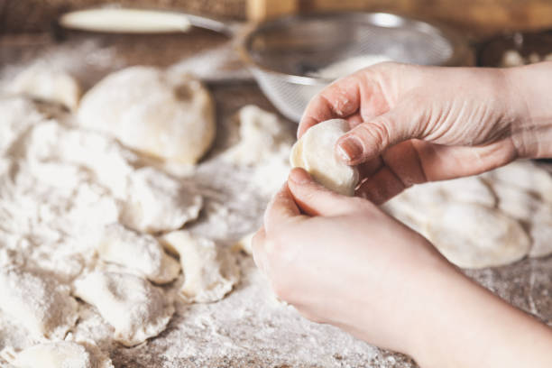 istock hands of woman make dumpling over granite table 939929520