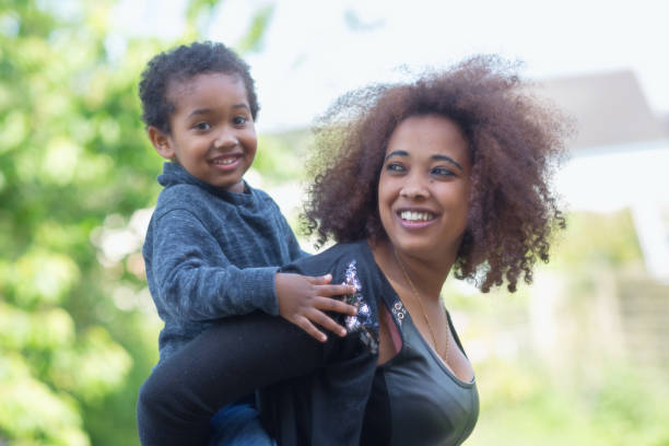 istock Happy mother with son, piggyback 939930168