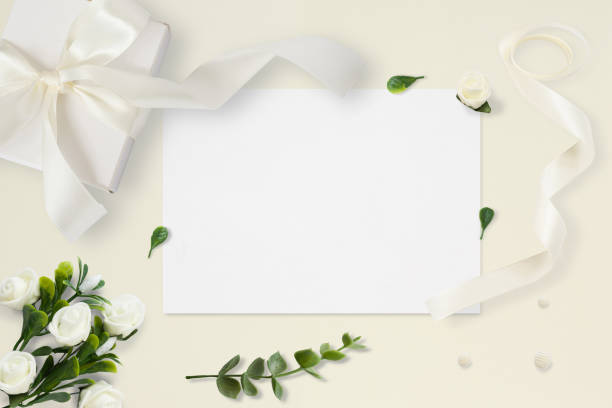 istock Letter, envelope and a present on pastel yellow background. Wedding invitation cards or love letter with chrysanthemums. Valentine's day or other holiday concept, top view, flat lay, overhead view. 939930554