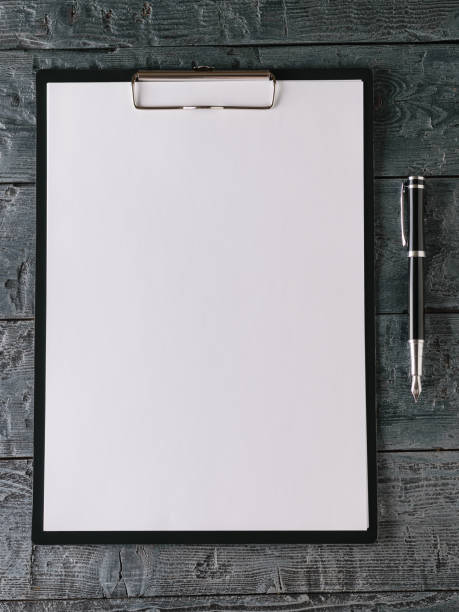 istock Notebook with pen on dark wooden table. The view from the top. 939930746