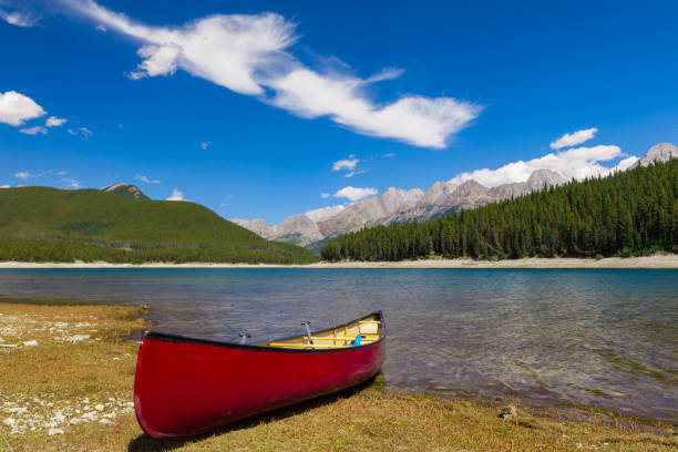 istock Red Canoe on the shore of a mountain lake 939934372