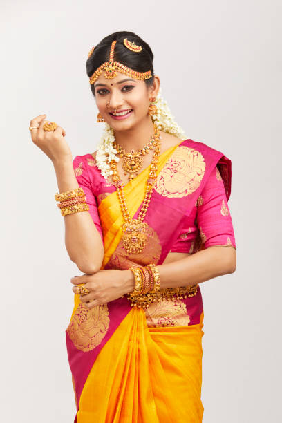istock Beautiful smiling Indian bride posing with jewelry 939937740