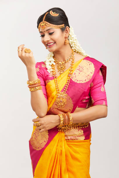 istock Beautiful smiling Indian bride posing with jewelry 939937752