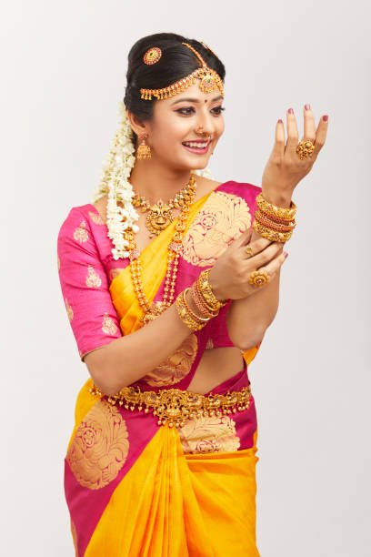 istock Beautiful smiling Indian bride posing with jewelry 939937796