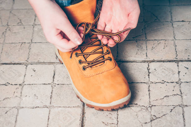 istock Close-up the boy is going on an expedition, tying shoelaces on hiking boots 939942124