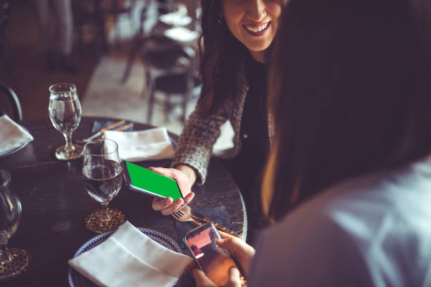 istock Businesswomen in cafe using smart phone 939942500