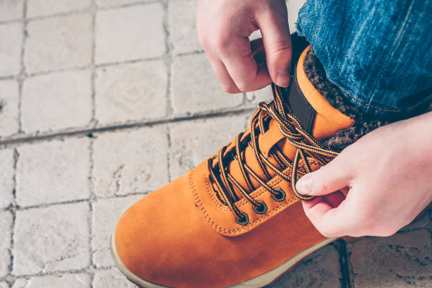 istock Close-up the boy is going on an expedition, tying shoelaces on hiking boots 939942892