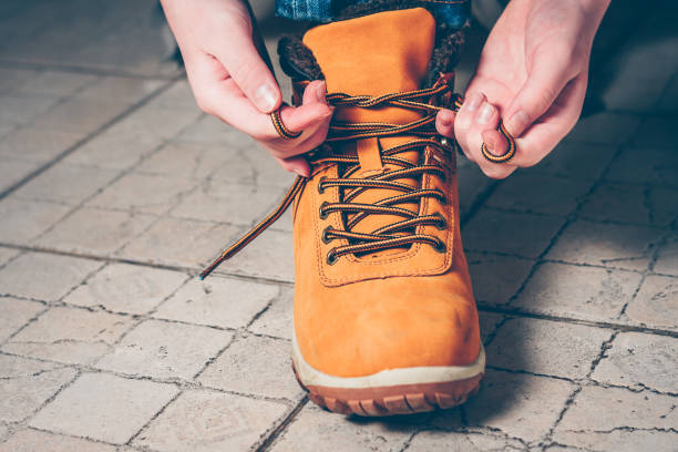istock Close-up the boy is going on an expedition, tying shoelaces on hiking boots 939943078