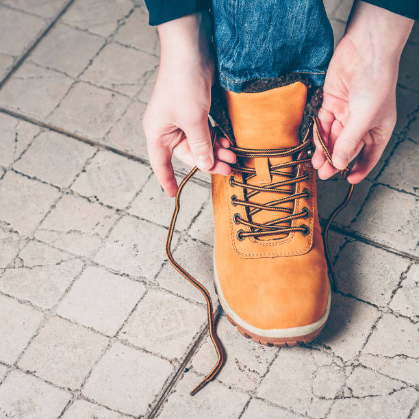 istock Close-up the boy is going on an expedition, tying shoelaces on hiking boots 939943656