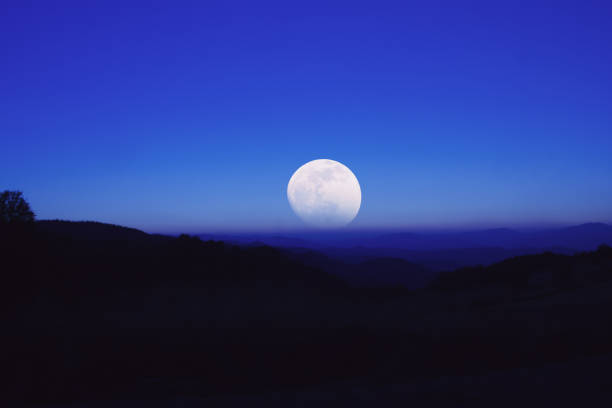 istock Full Moon rising from the mountain silhouettes landscape. My astronomy work. 939946088