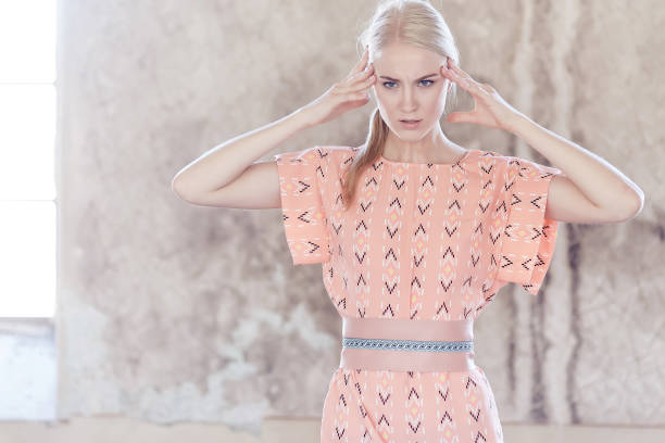 istock Blond female dressed in a light pink summer dress. 939946572