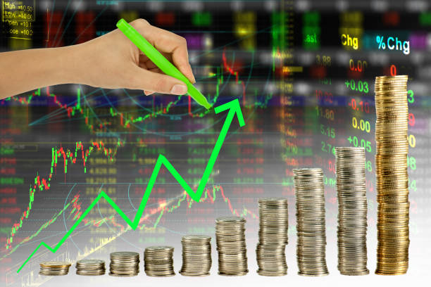 istock Hand writing green graph in coin stock index background 939947558