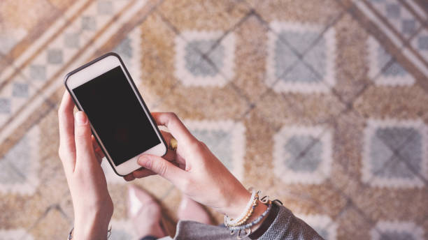 istock Stand up woman holding mobile phone 939947726