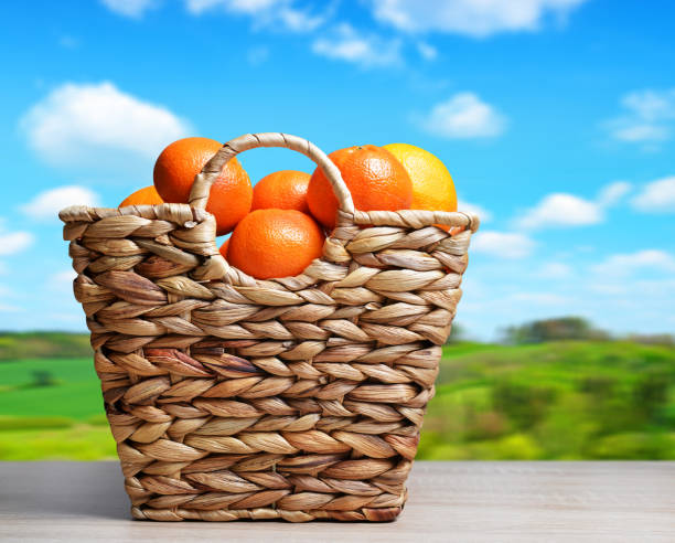 istock Ripe mandarin orange in wooden basket. 939948402