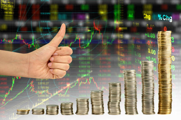 istock Hand showing good in graph  from coin mix stock exchange graph background 939948752