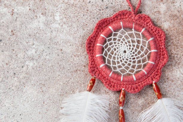 istock Coral dreamcatcher on concrete background 939956322