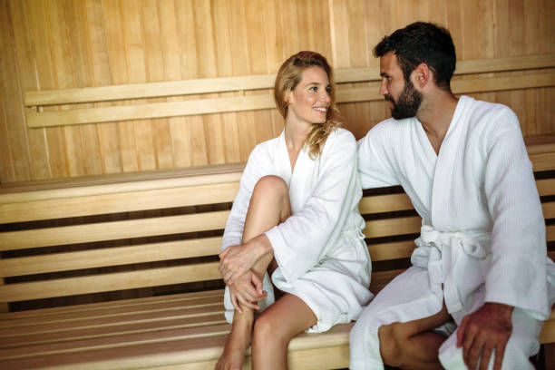 istock Attractive happy couple relaxing in spa center 939957472