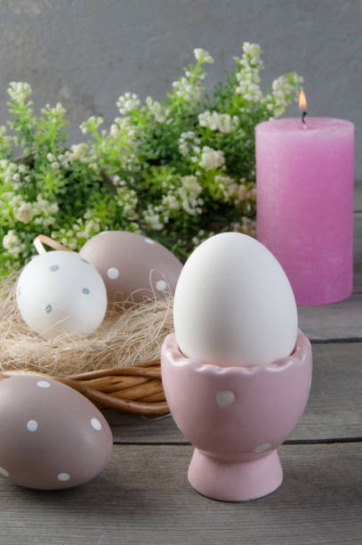 istock Eggs and rose aroma candle on old wooden background 939957654