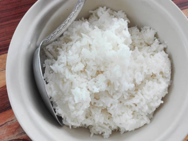 istock Closeup of white steamed rice in ceramic bowl 939957776