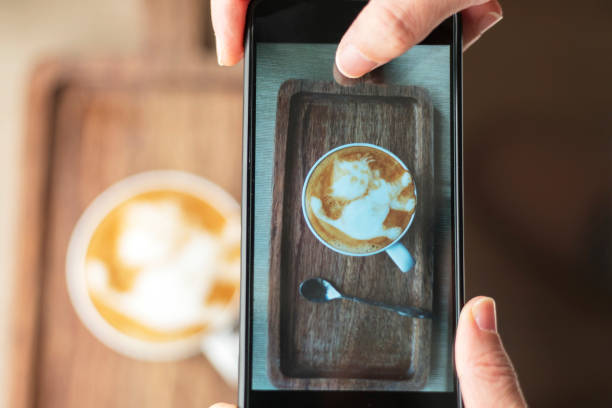 istock Photographing latte coffee with mobile phone 939957778