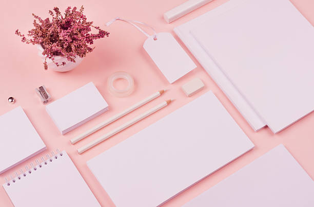 istock Pastel soft pink stylish working space with dry flowers lavender and blank notepad, letterhead, business card, coffee cup. Template for your design. 939958110