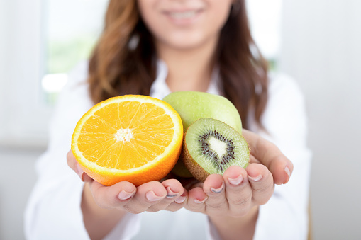 Doctor holds some fruits